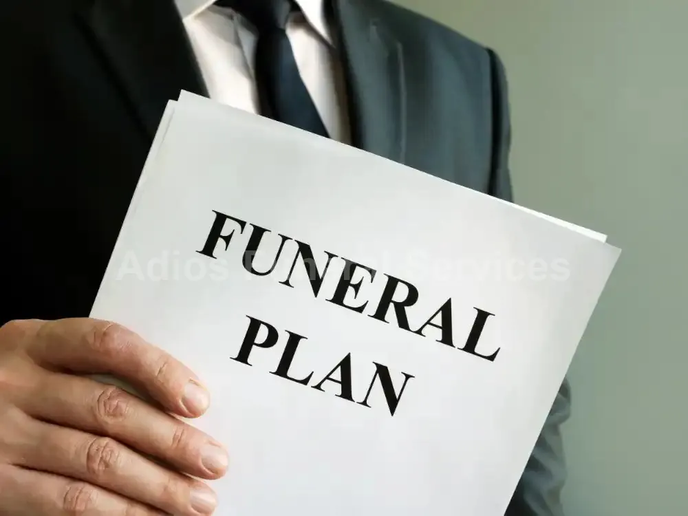 Funeral plan document held by an Adios team member