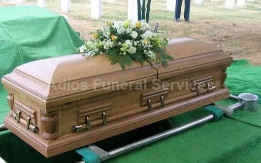 Casket being lowered at a graveside with lowering gear