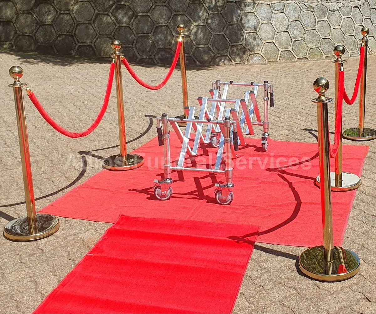 Graveside setup with red carpet and stanchions